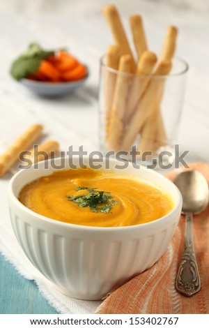 Bowl of homemade carrot soup with coconut milk and coriander