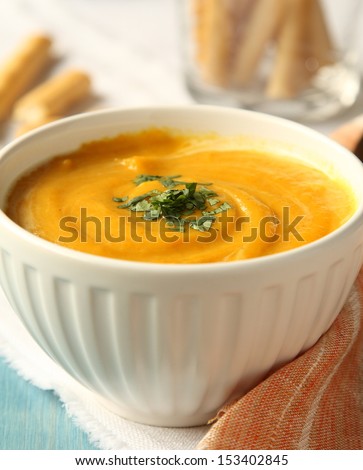 Bowl of homemade carrot soup with coconut milk and coriander