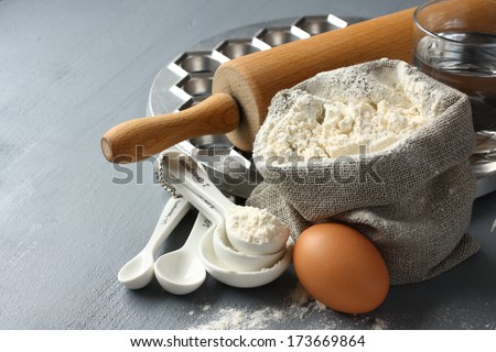 Ingredients and tools to make russian pelmeni on gray background