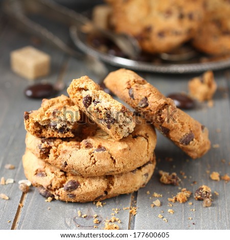Stacked chocolate chip cookies on rustic wooden background