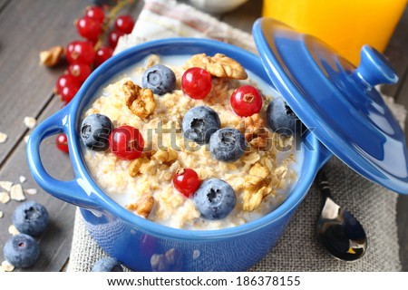 Healthy Tasty Homemade Oatmeal with Berries and glass of juice for Breakfast