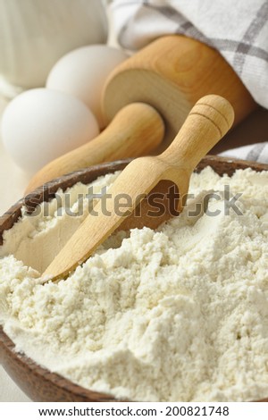 Homemade gluten free flour blend from rice flour, millet flour, potato starch and xanthan gum in wooden bowl met scoop