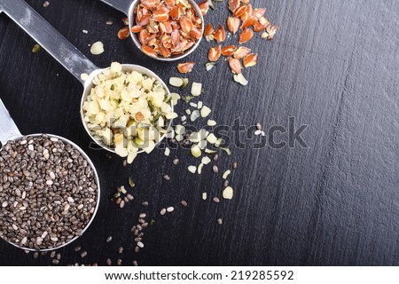 Superfoods. Chia seeds, hemp seeds and broken flax seeds in measuring spoons