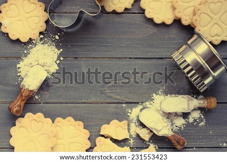 Background of baking gluten free shortbread cookies with utensils and ingredients,  viewed from above, toned