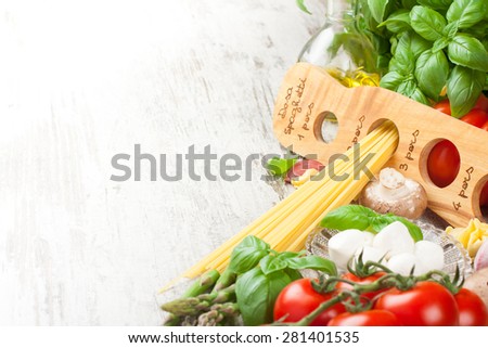 Italian food background. Ingredients for cooking, tomatoes, spaghetti, mushrooms, spaghetti meter on vintage white table. Copy space. Healthy food concept.