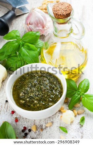 Homemade green basil pesto sauce and fresh ingredients. Italian Cuisine. Selective focus. Healthy food, diet and cooking concept.