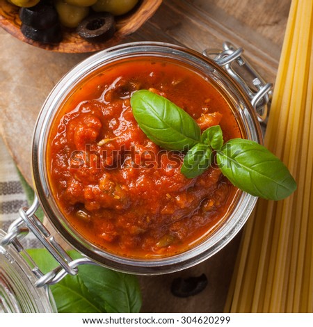 Traditional homemade tomato sauce with spaghetti and ingredients. Italian healthy food background. View from above.