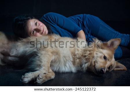 pretty lady and her lovely dog - studio shots on black background