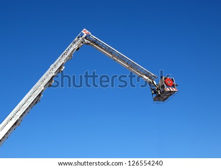 Fire carrycot with water cannon to extinguish a fire from a height on a background blue sky