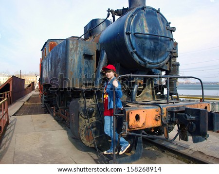 A girl walks down the stairs of the old steam locomotive