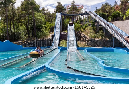 TBILISI, GEORGIA - JULY 03: Water game in a hollowed trunk at an amusement park \