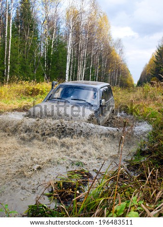 NIZHNY TAGIL. RUSSIA - JUNE 12, 2013: The third stage of the Russian Cup for Cross-Country Trials. Wheel drive vehicle leaves the swamp