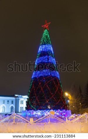 Large Christmas tree with star and garland on the town square