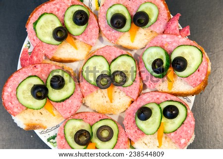 Sandwiches with salami, cucumber and olives