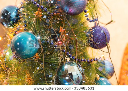 Christmas and New Year Decoration. Christmas ball hanging on a Christmas tree. Bright garlands and snow
