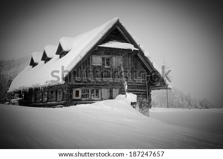 old, wooden, snowy ski lodge in the Alps