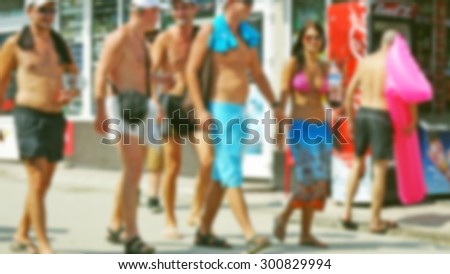 Blurred young people walking on the street of summer resort