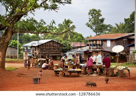 PAKSONG-JULY 28: Small food market in a Laotian village. Buy and sell vegetables and fruits close to the road through the village on july 28, 2009 in a village near to Paksong, Laos