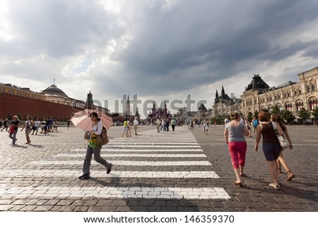 MOSCOW-JULY 20: In summer, tourists and passersby walking down the red square in Moscow where you can visit the tomb of Lenin, the Gum, and the Cathedral of St. Basil on july 20, 2010 in Moscow Russia