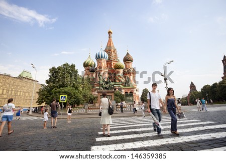 MOSCOW-JULY 20: Many tourists visit St. Basil\'s Cathedral on Red Square in Moscow, and taking pictures in front of the cathedral on july 20, 2010 in Moscow Russia