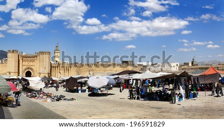 FEZ-APRIL 23: Moroccans selling clothes on local market, many people watching and buying; Fes-Boulemane region, North Africa on april 23 in Fez, Morocco