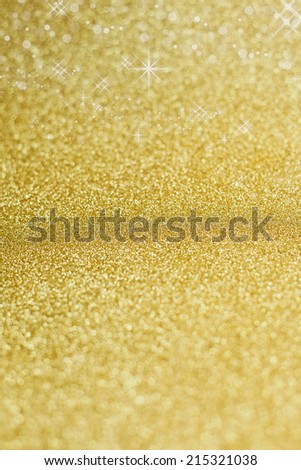 Christmas on background in gold with sparkling stars