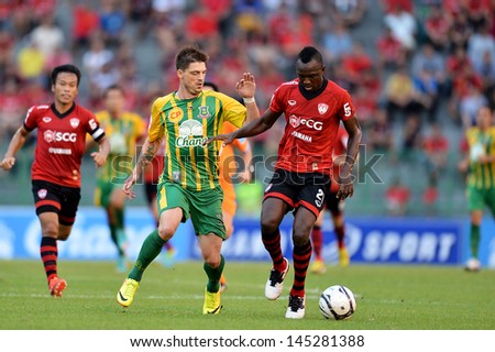 Bangkok,Thailand-July 6:Dagno Siaka (Red) Of Mtutd Run With The Ball During The Thai Premier League Between Army United And Maungthong United At Army Stadium On Jul6,2013 In Bangkok,Thailand.