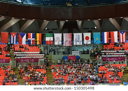 BANGKOK,THAILAND-AUGUST 16,2013:Unidentified supporters on stand cheer and flag of the nation during FIVB Volleyball World Grand Prix 2013 at Indoo stadium on August 16,2013 in Bangkok,Thailand