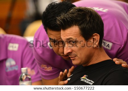 BANGKOK,THAILAND-AUGUST15,2013:Guidetti Giovanni (R) head coach of Germany at meeting room during press conference FIVB Volleyball WGP 2013 at Golden Tulip hotel on August15,2013 in Bangkok,Thailand
