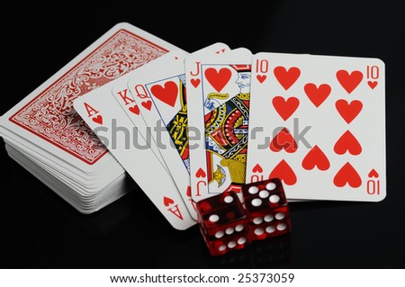 Cards and red dices on a black background