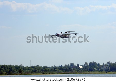 VOLGA RIVER, KONAKOVO, RUSSIA - JULY 31: Russian amphibious aircraft (flying boat) BE-200, preparing for the abstraction of water from the river to extinguish a forest fire.