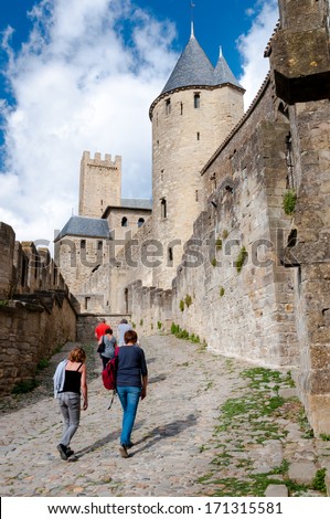Tourists walkig in the walls of Carcassonne medieval city in France