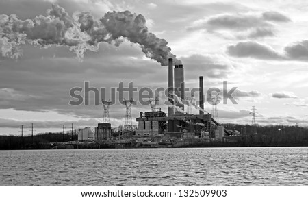 Coal fired power plant spewing smoke into the air.