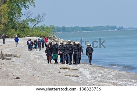 PORT CLINTON, OH-MAY 14: Bird watchers walk the beach and celebrate the migration of nearly 350 species of birds between habitats in North America, Latin America, and Mexico, on May 14, 2013.