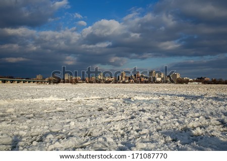 Late afternoon Harrisburg PA skyline on a cold winters day with the frozen river in the foreground.