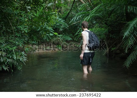 Man trekking through tropical Rain forest jungle in Okinawa, Japan