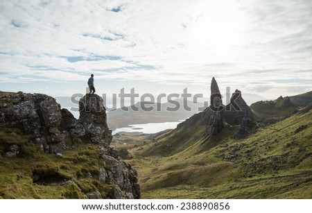 Man vs Nature, overlooking a stunning view of old rock pinnacle from a cliff top in the Isle of Skye, Scotland. Old Man of Storr.
