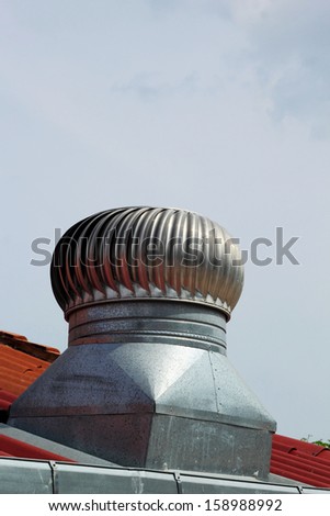 stainless steel exhaust fan on roof with blue sky