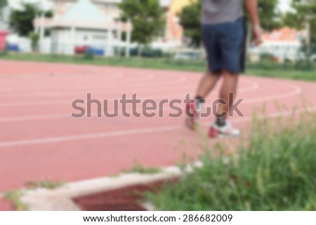 Blurred man running track for in the stadium.