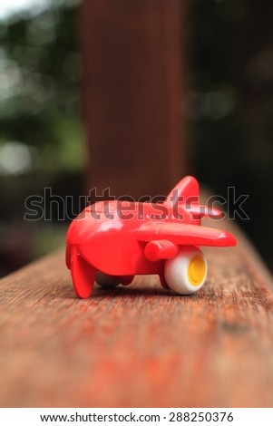 Toy plane with a red propeller.