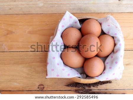 Chicken brown eggs on wood background