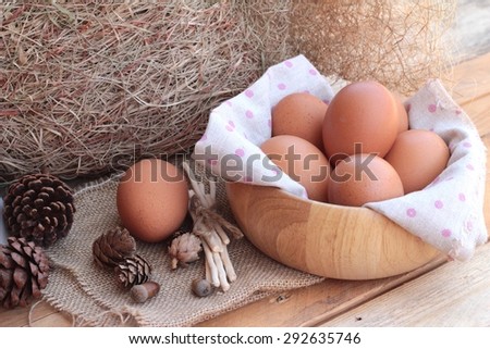 Chicken brown eggs on wood background