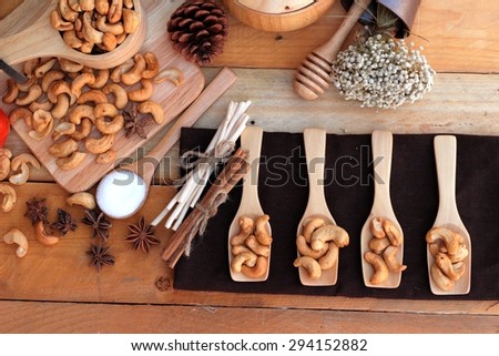 Roasted cashews nuts with natural on wood background