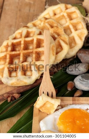 Sweet waffles and fresh milk with jam and egg heart