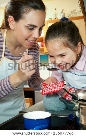 Little girl help her mother in kitchen