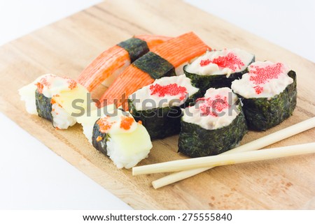 sushi in wooden plate on white background