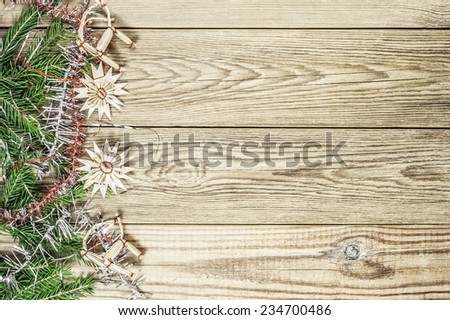 Fir branches, star and sheep toys on a wooden background