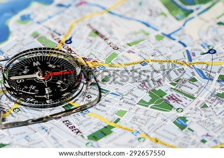 Close-up of a compass on a background map of the city of Hamburg