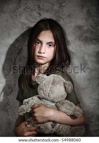 Sad little girl with toy