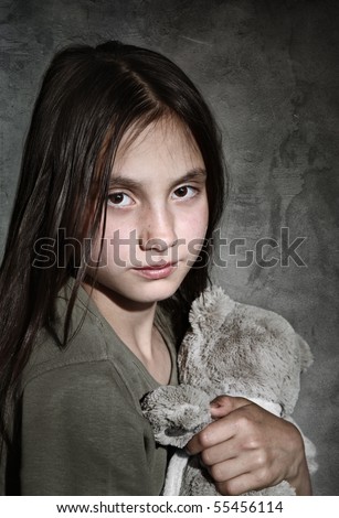 Portrait of sad girl with toy